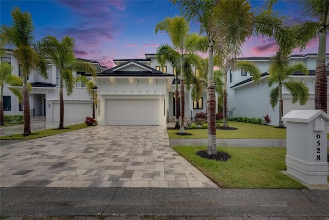 6528 Simone Shores Cir, Apollo Beach, FL 33572 - view of front of house with decorative driveway, a front yard, stucco siding, and a garage