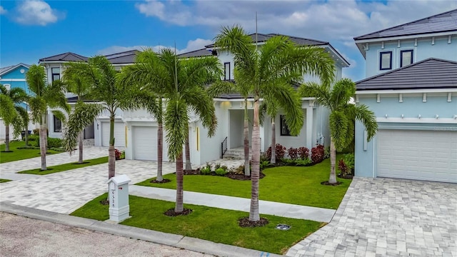6528 Simone Shores Cir, Apollo Beach, FL 33572 - view of front facade featuring decorative driveway, a front lawn, and stucco siding