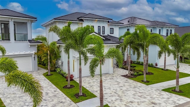 6528 Simone Shores Cir, Apollo Beach, FL 33572 - view of front of home with a garage, decorative driveway, a front yard, and stucco siding