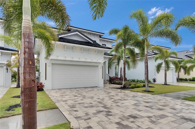 6528 Simone Shores Cir, Apollo Beach, FL 33572 - view of front of house with decorative driveway, a garage, and stucco siding