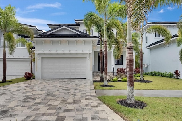6528 Simone Shores Cir, Apollo Beach, FL 33572 - view of front of property featuring decorative driveway, stucco siding, a front lawn, and a garage