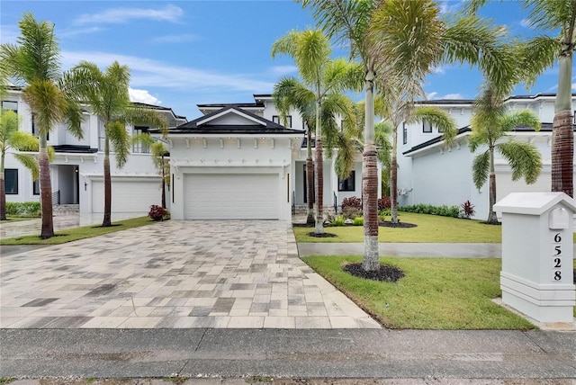 6528 Simone Shores Cir, Apollo Beach, FL 33572 - view of front of property with decorative driveway, a front lawn, stucco siding, and a garage
