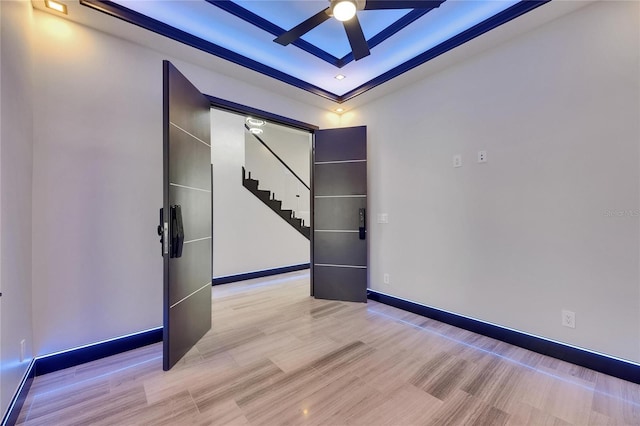 6528 Simone Shores Cir, Apollo Beach, FL 33572 - unfurnished room with ceiling fan, stairs, light wood-type flooring, baseboards, and a tray ceiling