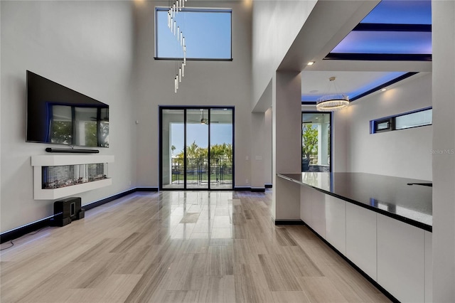 6528 Simone Shores Cir, Apollo Beach, FL 33572 - unfurnished living room featuring baseboards and a high ceiling