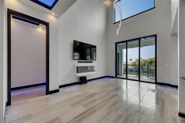6528 Simone Shores Cir, Apollo Beach, FL 33572 - unfurnished living room with a high ceiling and baseboards