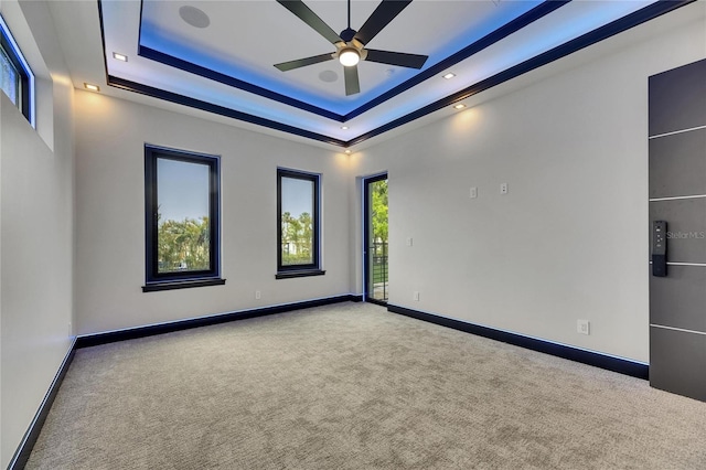 6528 Simone Shores Cir, Apollo Beach, FL 33572 - carpeted empty room with a ceiling fan, a raised ceiling, and baseboards