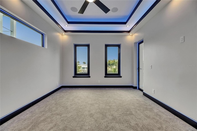 6528 Simone Shores Cir, Apollo Beach, FL 33572 - carpeted spare room with a ceiling fan, a tray ceiling, and baseboards
