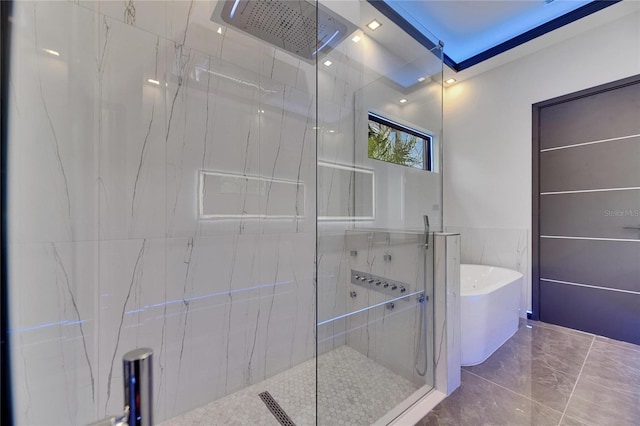 6528 Simone Shores Cir, Apollo Beach, FL 33572 - full bathroom featuring a tile shower, a soaking tub, and tile walls