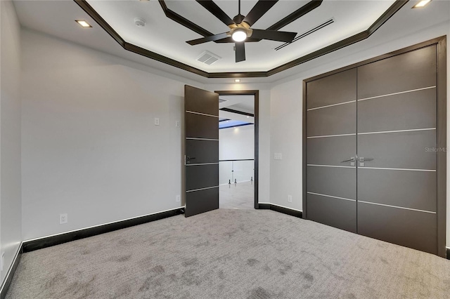 6528 Simone Shores Cir, Apollo Beach, FL 33572 - unfurnished bedroom with carpet floors, baseboards, crown molding, and a tray ceiling