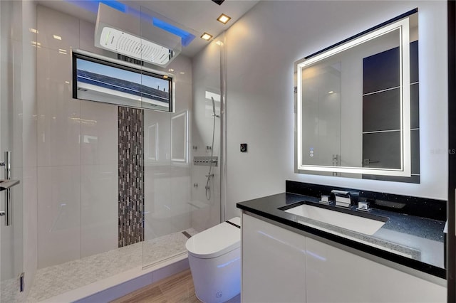 6528 Simone Shores Cir, Apollo Beach, FL 33572 - bathroom featuring a tile shower, toilet, and vanity