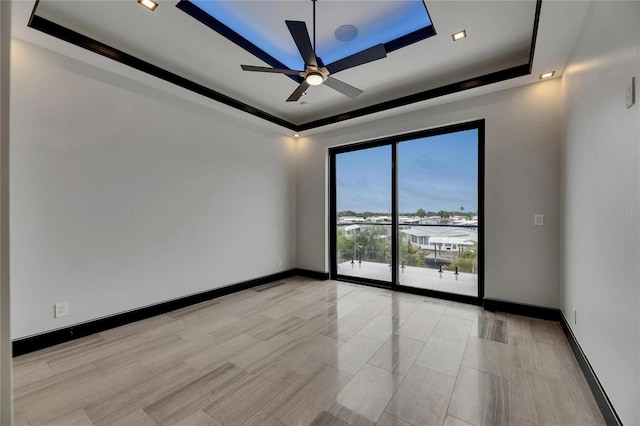 6528 Simone Shores Cir, Apollo Beach, FL 33572 - unfurnished room featuring a tray ceiling, ceiling fan, and baseboards
