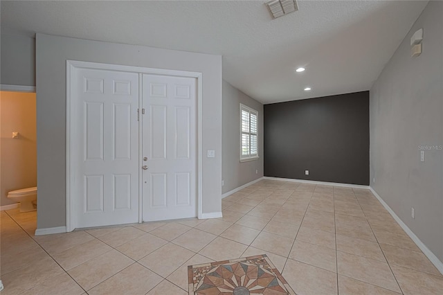 20109 Bay Cedar Ave, Tampa, FL 33647 - unfurnished bedroom featuring light tile patterned floors, baseboards, recessed lighting, and ensuite bathroom