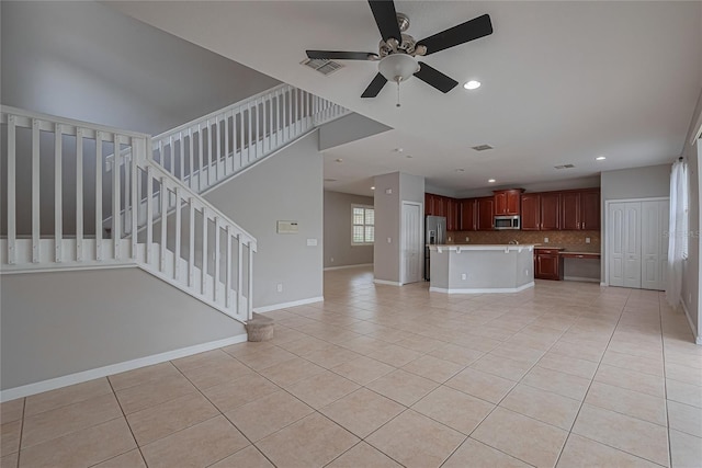 20109 Bay Cedar Ave, Tampa, FL 33647 - unfurnished living room featuring light tile patterned floors, a ceiling fan, recessed lighting, stairs, and baseboards