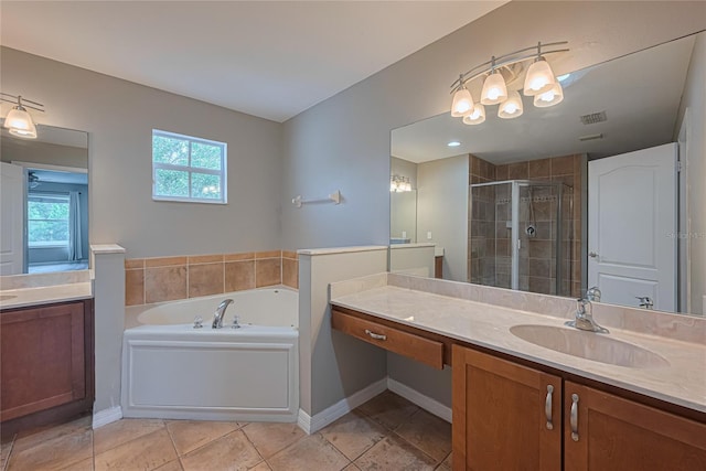 20109 Bay Cedar Ave, Tampa, FL 33647 - full bath with a stall shower, vanity, a garden tub, tile patterned flooring, and a chandelier