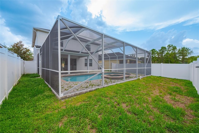 20109 Bay Cedar Ave, Tampa, FL 33647 - back of house with an in-ground hot tub and glass enclosure