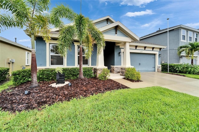 6127 Colmar Pl, Apollo Beach, FL 33572 - view of front of home featuring an attached garage, concrete driveway, stucco siding, and a front lawn