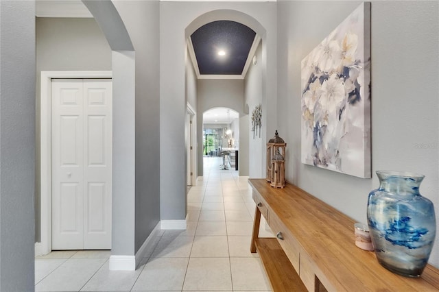 6127 Colmar Pl, Apollo Beach, FL 33572 - hallway with arched walkways, light tile patterned flooring, ornamental molding, and baseboards