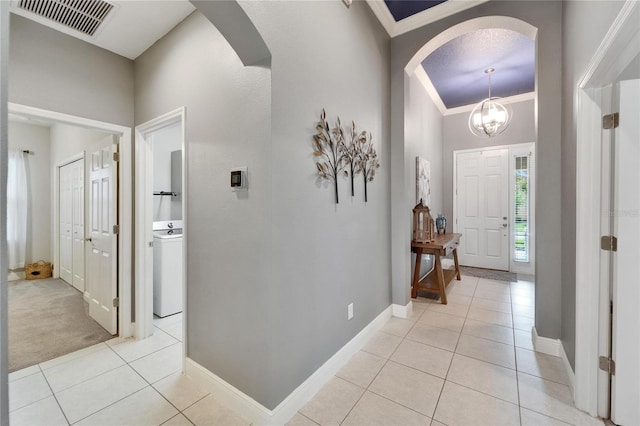 6127 Colmar Pl, Apollo Beach, FL 33572 - entrance foyer with arched walkways, light tile patterned floors, crown molding, and baseboards