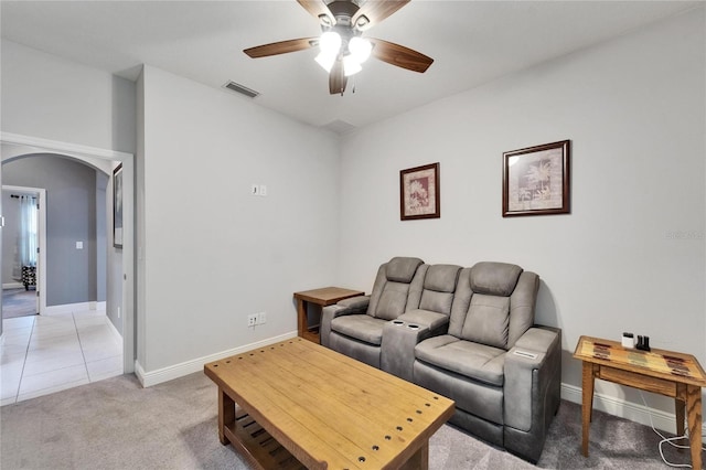 6127 Colmar Pl, Apollo Beach, FL 33572 - living room featuring arched walkways, ceiling fan, baseboards, and light carpet