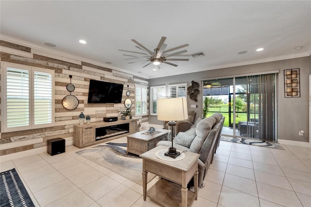 6127 Colmar Pl, Apollo Beach, FL 33572 - living area featuring ornamental molding, ceiling fan, baseboards, a fireplace, and light tile patterned flooring