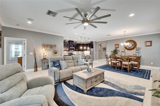 6127 Colmar Pl, Apollo Beach, FL 33572 - living room with light tile patterned floors, a chandelier, a ceiling fan, arched walkways, and recessed lighting