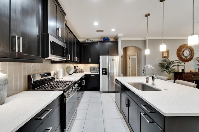 6127 Colmar Pl, Apollo Beach, FL 33572 - kitchen featuring appliances with stainless steel finishes, a sink, ornamental molding, arched walkways, and tasteful backsplash