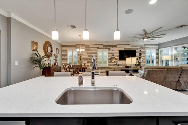 6127 Colmar Pl, Apollo Beach, FL 33572 - kitchen with a sink, light countertops, open floor plan, ornamental molding, and a center island with sink