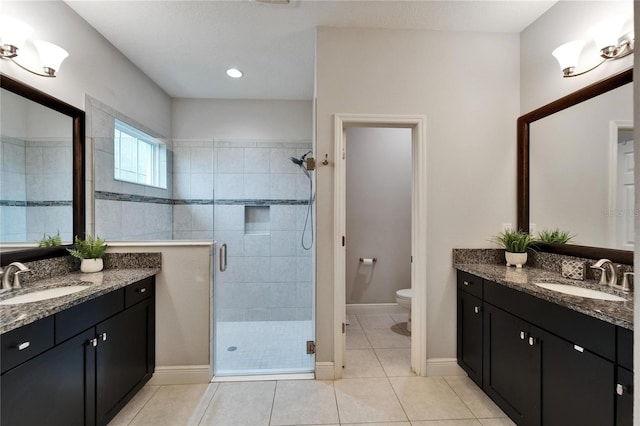 6127 Colmar Pl, Apollo Beach, FL 33572 - bathroom with two vanities, a shower stall, toilet, and tile patterned floors