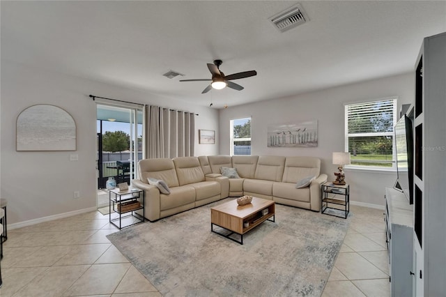 449 Bahama Grande Blvd, Apollo Beach, FL 33572 - living area with light tile patterned floors, ceiling fan, and healthy amount of natural light