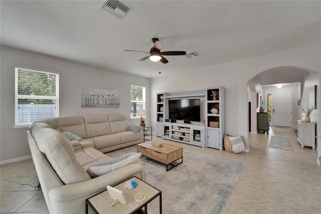 449 Bahama Grande Blvd, Apollo Beach, FL 33572 - living room with arched walkways, ceiling fan, light tile patterned floors, and baseboards