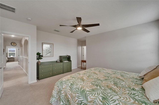 449 Bahama Grande Blvd, Apollo Beach, FL 33572 - bedroom with light colored carpet, ceiling fan, arched walkways, and baseboards