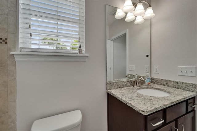 449 Bahama Grande Blvd, Apollo Beach, FL 33572 - bathroom featuring a chandelier, vanity, and toilet