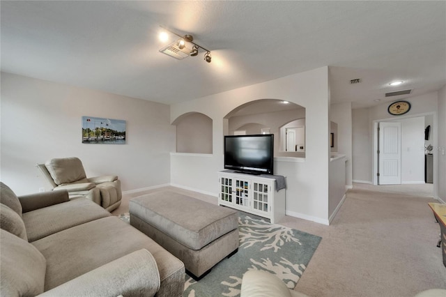 449 Bahama Grande Blvd, Apollo Beach, FL 33572 - living room featuring light colored carpet, baseboards, and rail lighting