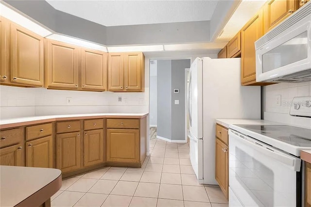 13377 Elise Ln, Spring Hill, FL 34609 - kitchen with white appliances, light countertops, and backsplash