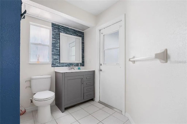 13377 Elise Ln, Spring Hill, FL 34609 - bathroom with vanity, toilet, baseboards, and tile patterned flooring