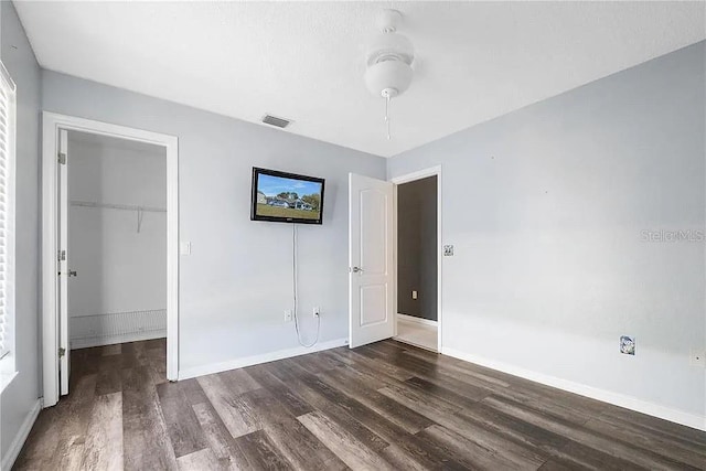 13377 Elise Ln, Spring Hill, FL 34609 - unfurnished bedroom with dark wood-style floors, a closet, and baseboards
