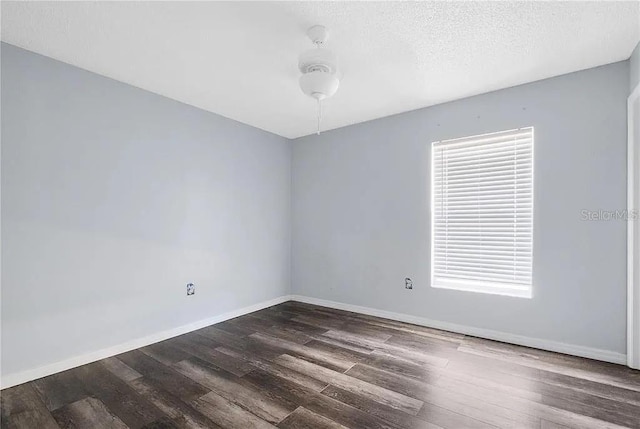 13377 Elise Ln, Spring Hill, FL 34609 - spare room with dark wood-style flooring, baseboards, and a textured ceiling