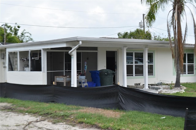 2470 Del Rio Way, Dunedin, FL 34698 - view of side of home featuring a sunroom