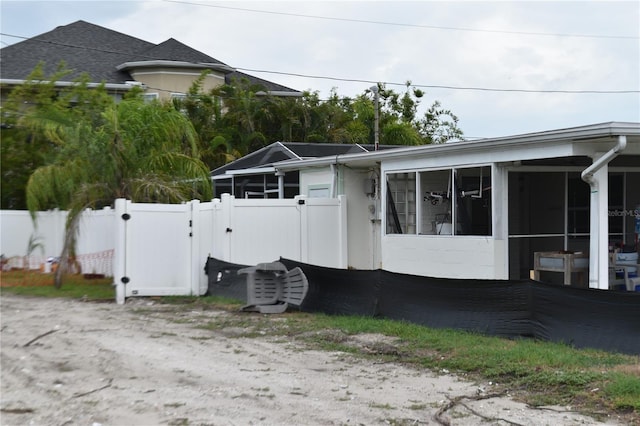 2470 Del Rio Way, Dunedin, FL 34698 - view of property exterior with a sunroom and a gate