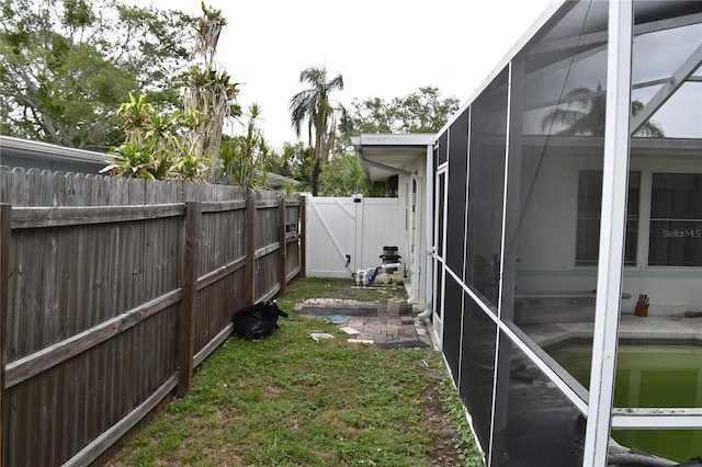 2470 Del Rio Way, Dunedin, FL 34698 - view of yard with glass enclosure and a gate