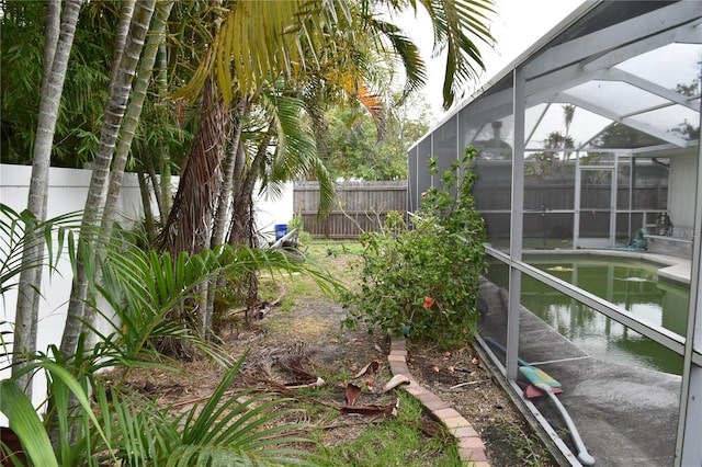 2470 Del Rio Way, Dunedin, FL 34698 - fenced backyard featuring a lanai