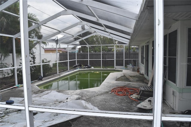 2470 Del Rio Way, Dunedin, FL 34698 - view of swimming pool featuring a fenced backyard, glass enclosure, and a patio