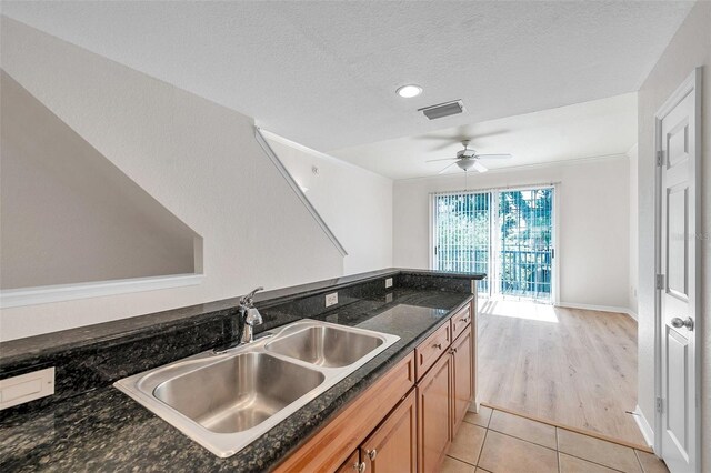 113 S Sherrill St Unit 113, Tampa, FL 33609 - kitchen with a sink, a ceiling fan, light tile patterned floors, a textured ceiling, and baseboards