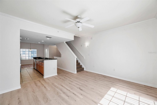 113 S Sherrill St Unit 113, Tampa, FL 33609 - kitchen with light wood-type flooring, a ceiling fan, crown molding, baseboards, and a center island