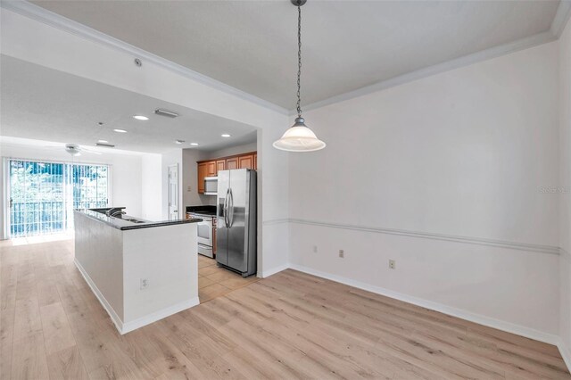113 S Sherrill St Unit 113, Tampa, FL 33609 - kitchen featuring appliances with stainless steel finishes, light wood finished floors, baseboards, brown cabinetry, and dark countertops