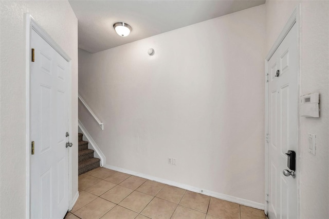 113 S Sherrill St Unit 113, Tampa, FL 33609 - foyer entrance featuring light tile patterned floors, stairs, and baseboards