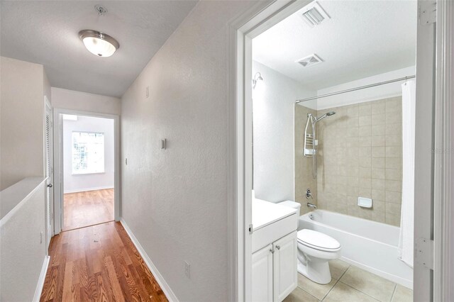 113 S Sherrill St Unit 113, Tampa, FL 33609 - bathroom with toilet, vanity, shower / tub combo, wood finished floors, and a textured wall