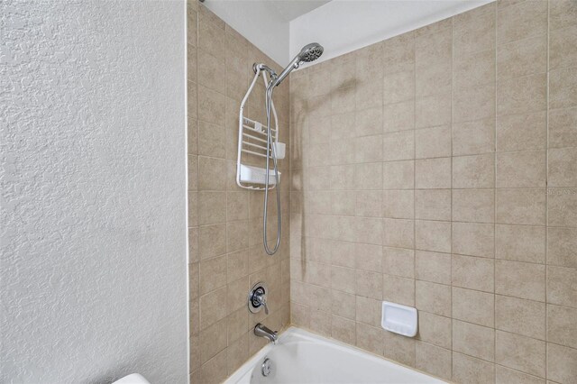 113 S Sherrill St Unit 113, Tampa, FL 33609 - full bath with  shower combination and a textured wall