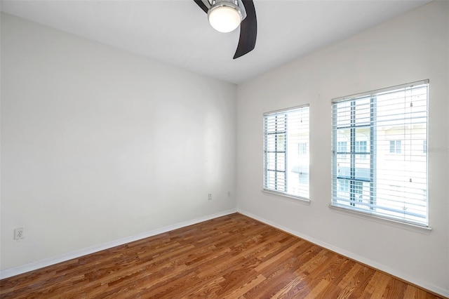 113 S Sherrill St Unit 113, Tampa, FL 33609 - spare room with a ceiling fan, wood finished floors, and baseboards