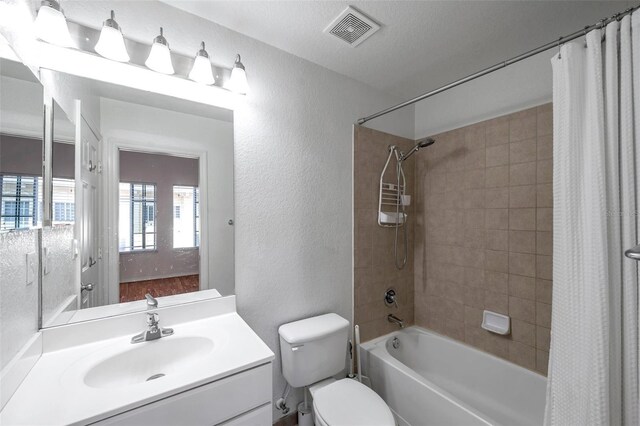 113 S Sherrill St Unit 113, Tampa, FL 33609 - bathroom featuring a textured wall, shower / tub combo with curtain, vanity, and toilet